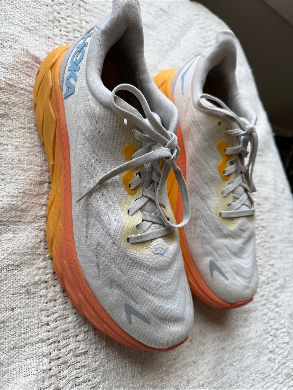 Hoka women’s Sneakers in Light Gray with Orange & Yellow Accents